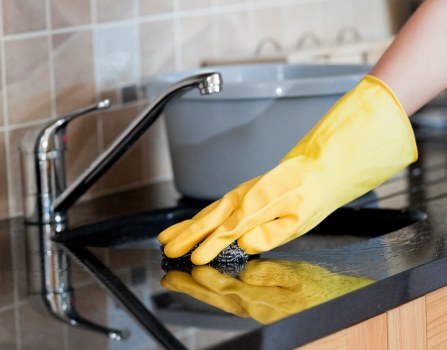 Professional window cleaner working on a residential building